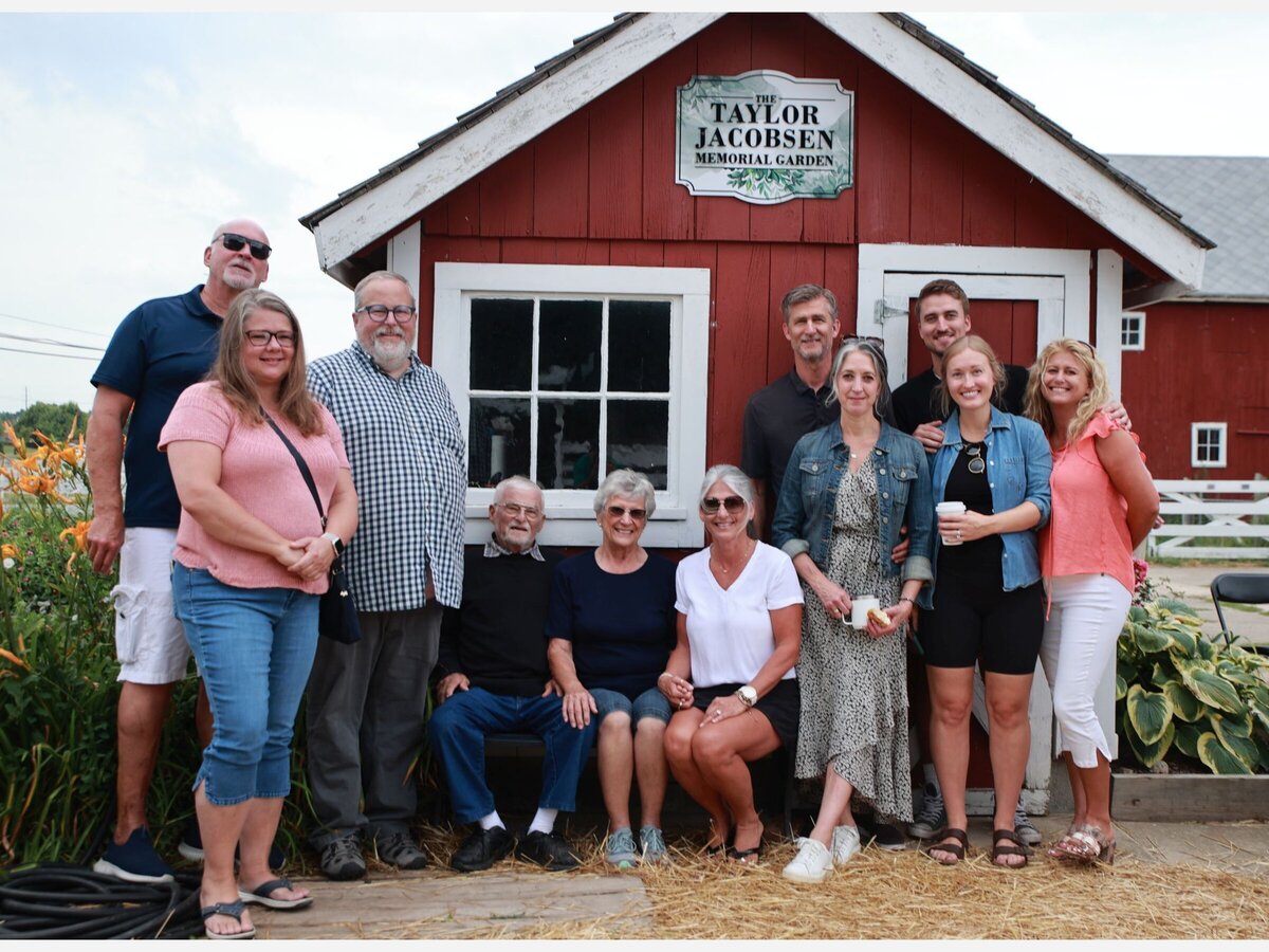 The family of Taylor Jacobsen is pictured in front of the shed in the Taylor Jacobsen Memorial Garden.