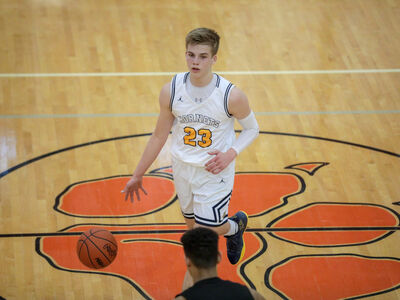 BASKETBALL: Saline Upsets Huron in Overtime to Advance in Districts
