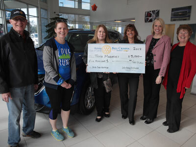 Saline Rotary, Crispin Chevrolet Present Winner with $5,000 Check